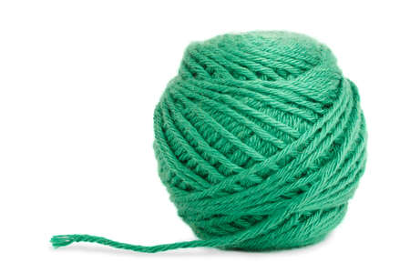 a green wool ball on white ground