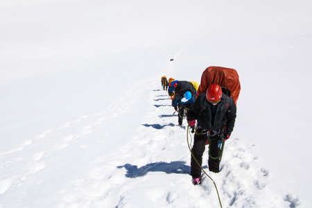 Altai, Russia - July 11, 2014: Climbers at the mountain summit in on the way to the top of Beluhaのeditorial素材