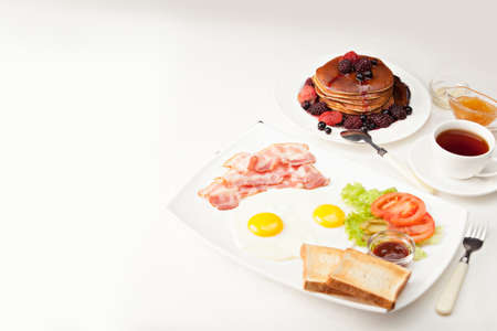Pancakes with Bacon and Eggs on morning breakfast tableの写真素材