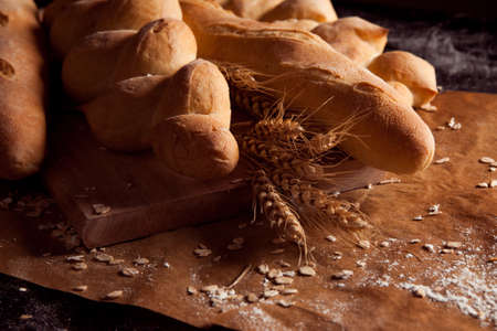 Assortment of baked bread on floured paper