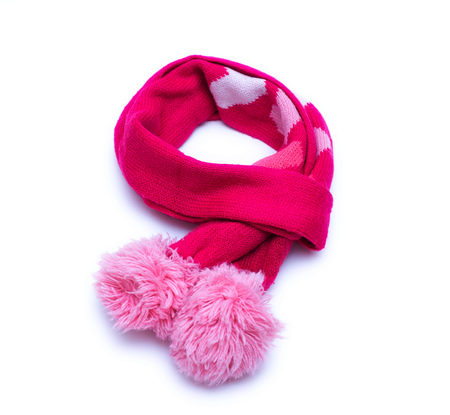 Knitted red scarf with pompoms with on white backgroundの写真素材