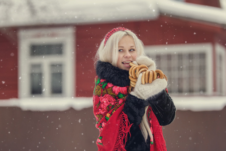 Portrait of a young caucasian woman in russian style on a strong frost in a winter snowy day. Russian model girl in traditional dressの写真素材