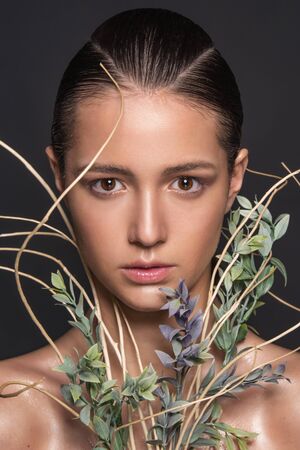 Emotional fashion portrait of beautiful women with bright makeup on wet face. Studio photo on a black backgroundの写真素材