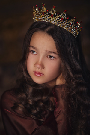 Portrait of cute girl wearing a crown. Young queen or princessの写真素材