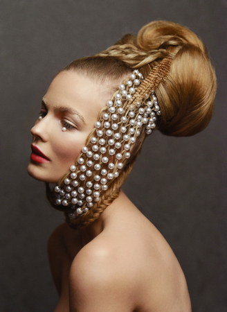 Beauty portrait of young woman with creative fashion hairstyleの写真素材