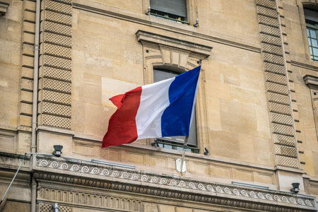 French flag waving in the wind on a building in Paris, Franceの写真素材