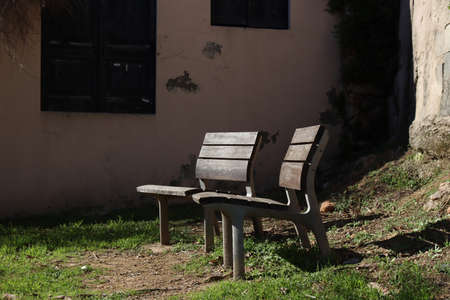 Two lonely trees benches in a small courtyard in Girona, Catalonia, Spain