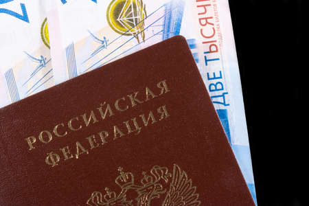 Two two thousandth banknotes of rubles with a passport of a citizen of Russia on a black backgroundの写真素材
