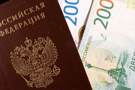 Russian banknote of two thousand and two hundred rubles with a Russian passport on a black backgroundの写真素材