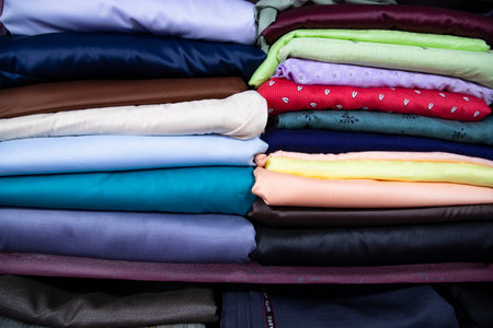 Patterned Textile Fabrics  stacked on a retail Shop Shelf for saleの写真素材