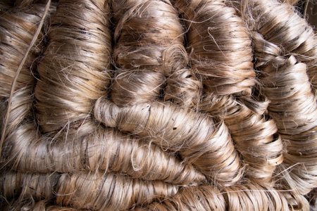 A thick bundle of Golden jute fiber Texture Background