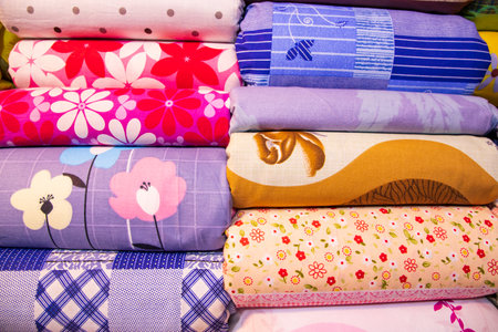 Artistic variety shade tone colors Bed sheets stacked on retail Shop Shelf to sale