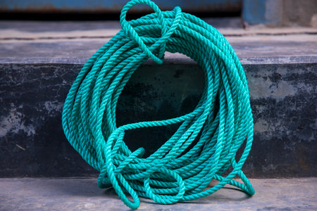 green rope tied up on the dock of the ship, stock photo