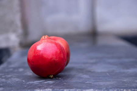 Ripe red pomegranate fruit on a dark background.の写真素材