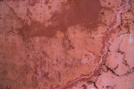 The texture of an old rustic wall is covered with pink stucco