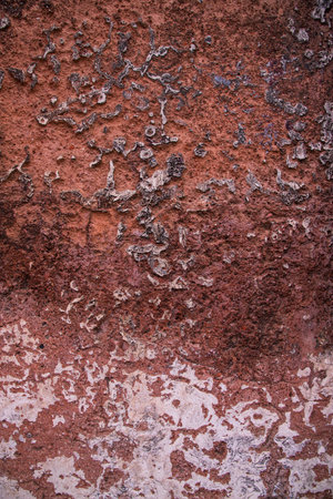 The texture of an old rustic wall is covered with red stucco. Abstract background for design