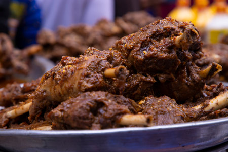Roasted leg pieces of mutton at a street food market in Dhaka, Bangladeshの写真素材