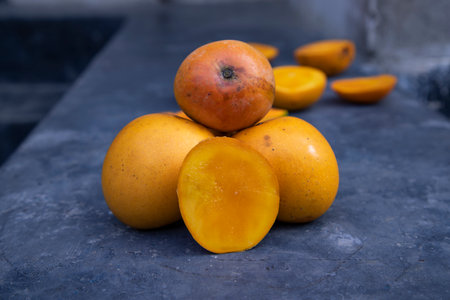 Ripe mango fruits on a dark background. Close-upの写真素材