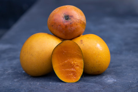 Ripe mango fruits on a dark background. Close-upの写真素材