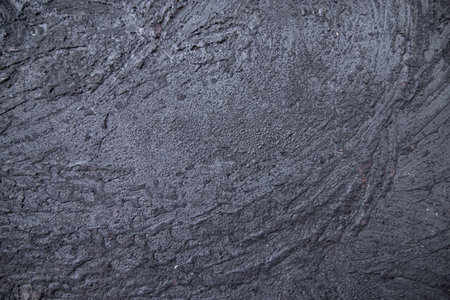 Old metal surface covered black ash abstract background texture