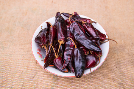 One bowl of Dry Pepper or red chili on the jute fiber fabric