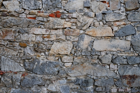 wall made of curves of limestone with mortarの写真素材