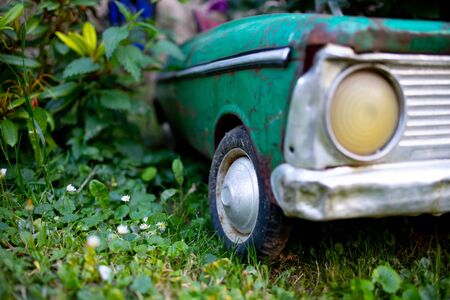 old rusty car - toy in gardenの写真素材