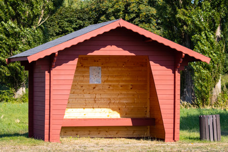 Wooden bus stop on a sunny summer day.の写真素材