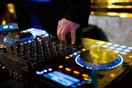 Dj mixer in nightclub, close-up of hands and turntables