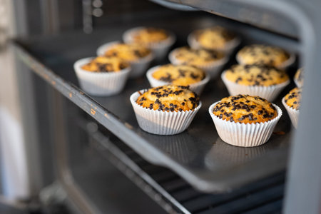 Freshly baked muffins on a baking sheet in the oven.の写真素材
