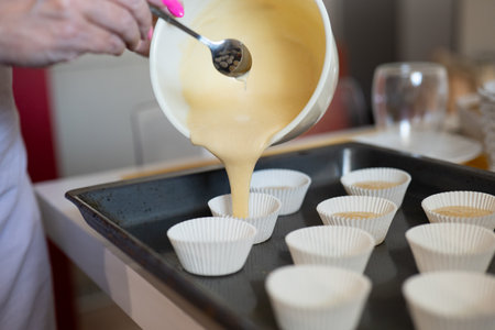 Close up of female hands making cupcakes in a pastry shop.の写真素材