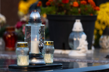 Candles on the grave of a dead person at the cemetery.