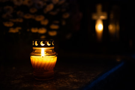 Candle light in a cemetery at night. Selective focus.の写真素材