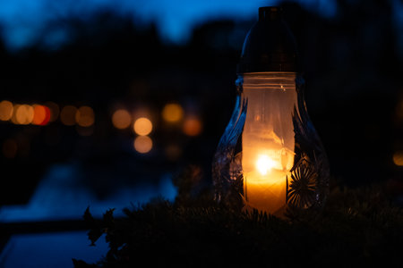 Candle light on the cemetery at night. Selective focus.