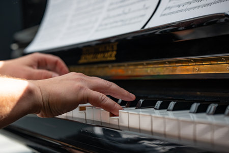 Close-up of male hands playing the piano. Focus on hands.の写真素材