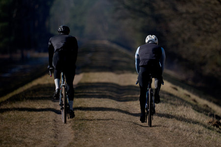 Cyclists riding on a dirt road in the countryside. Healthy lifestyle.の写真素材