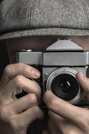 Old-fashioned Photographer. Close-up portrait of a photographer, who shot by vintage film camera.の写真素材