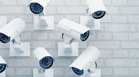 Total CCTV Security. Group of external surveillance cameras mounted on a brick wall. 3D rendering graphics on the theme of 'Modern Security Technology'.の写真素材