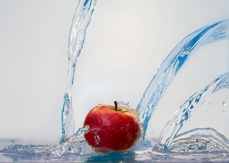 fresh apple and stream of crystal-clear waterの写真素材