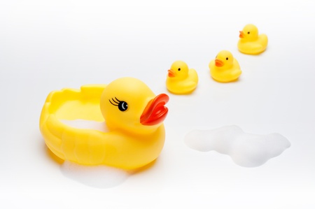 Yellow duck with babies in bathroomの写真素材