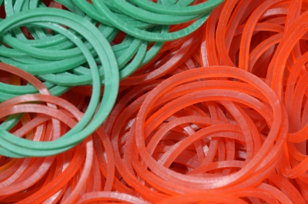close up of colourful rubber bands - green red