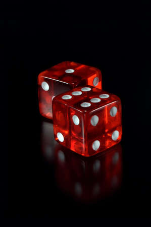 Two dices on a black background. Focus on a first dice.の写真素材