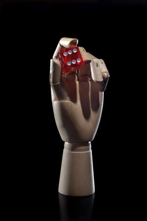 wooden mannequin hand with diceの写真素材