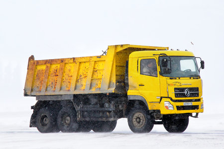 NOVYY URENGOY, RUSSIA - APRIL 7, 2013: Yellow DongFeng dump truck at the interurban road.のeditorial素材