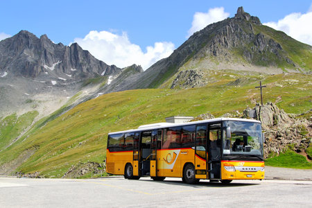GOTTHARD PASS, SWITZERLAND - AUGUST 5, 2014: Yellow Setra S415H interurban coach at the high Alpine mountain road.のeditorial素材