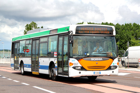 VENICE, ITALY - JULY 30, 2014: White city bus Scania OmniCity CN94UB at the city street.のeditorial素材