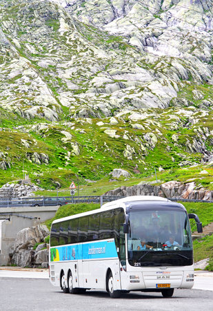 GOTTHARD PASS, SWITZERLAND - AUGUST 5, 2014: White touristic coach MAN R08 Lions Top Coach at the high Alpine mountain road.のeditorial素材