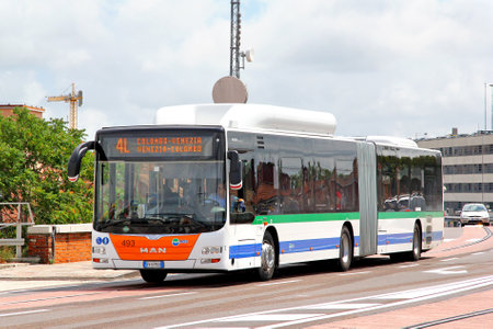 VENICE, ITALY - JULY 30, 2014: Articulated city bus MAN A23 Lions City G at the city street.のeditorial素材