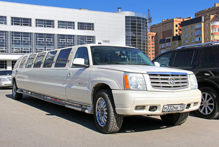UFA, RUSSIA - MAY 28, 2014: White Cadillac Escalade limousine at the city street.のeditorial素材