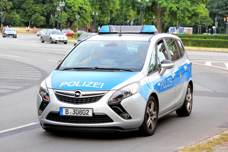 BERLIN, GERMANY - AUGUST 15, 2014: Modern police car Opel Zafira Tourer at the city street.のeditorial素材